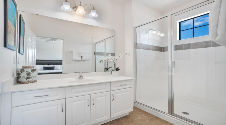 Bathroom with dual vanity and walk in shower.