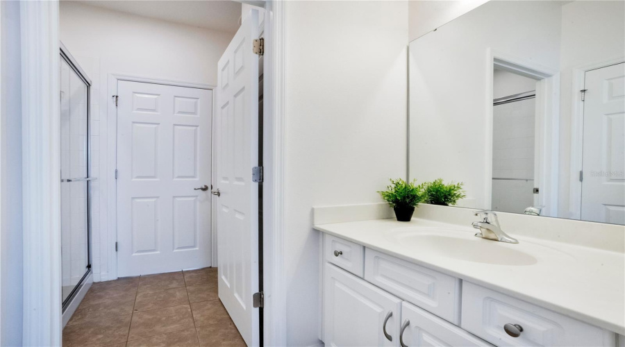 Bathroom with extended vanity and clean finishes.