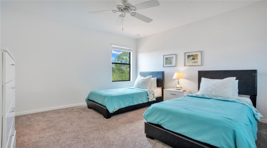 Twin bedroom setup ideal for guests or rental use.