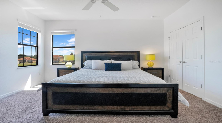 Spacious bedroom with large windows and privacy.