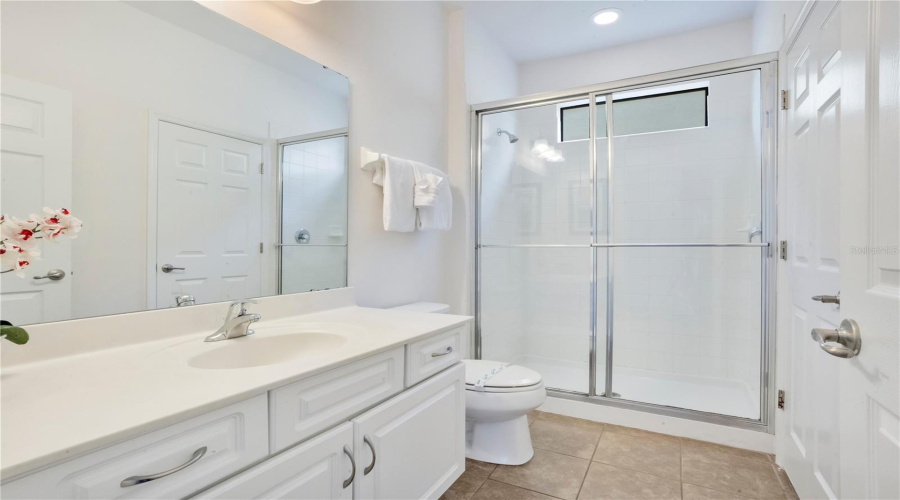Primary bathroom with walk in shower and vanity space.