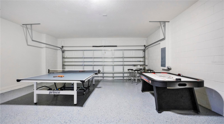 Garage converted game room with ping pong and pool table.