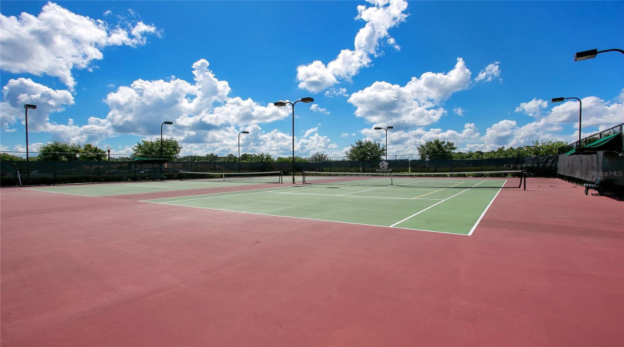 Tennis courts within community with open play space.