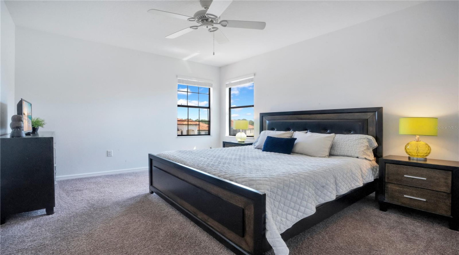 Spacious primary bedroom with natural light and private layout.