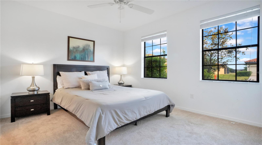 Bedroom on 1st floor with bright windows and neutral tones.