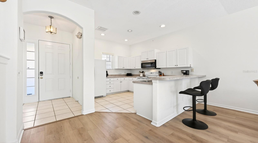 Well equipped kitchen offers casual dining at the breakfast bar and a neutral color palette.