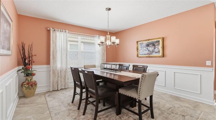 dining area/flex space with wainscoting
