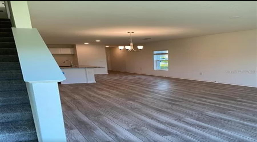 “Inviting open layout that connects the living room, dining area, and kitchen.”