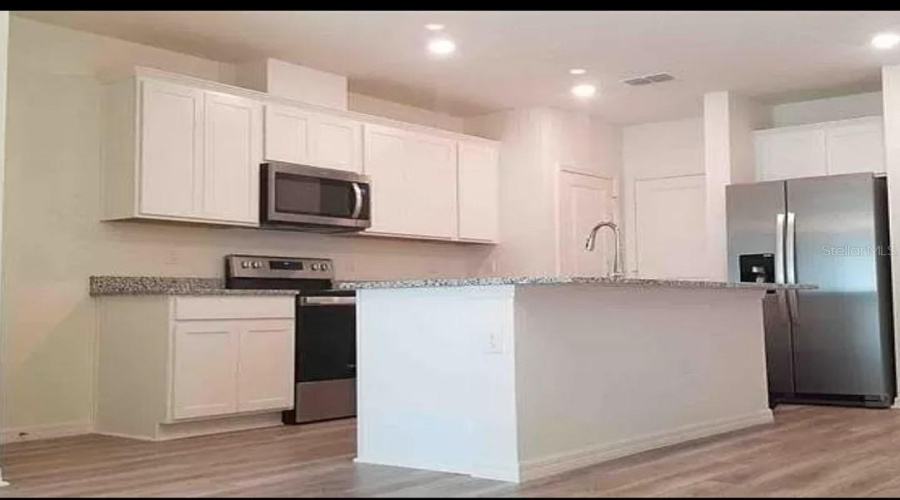 “Kitchen with practical design and open flow.”