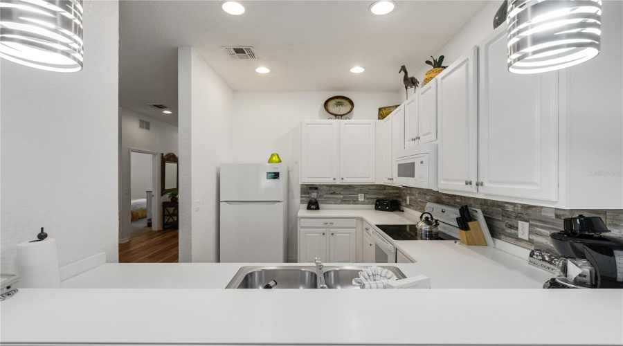 Breakfast bar is both practical and separate the kitchen from the living room