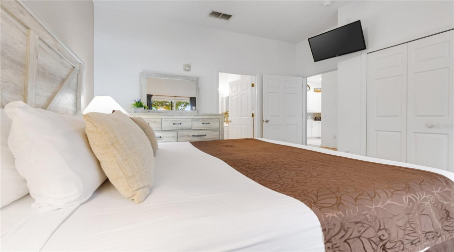 Primary bedroom benefits from king sized bedroom suite, large closet and sliding glass patio doors providing natural light and access to your private patio.