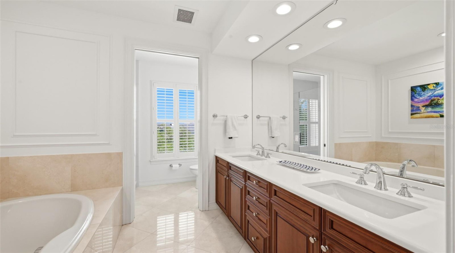 Primary Bath With New Updated Quartz Vanities with Plumbing fixtures, Marble Floors and Bath tiles