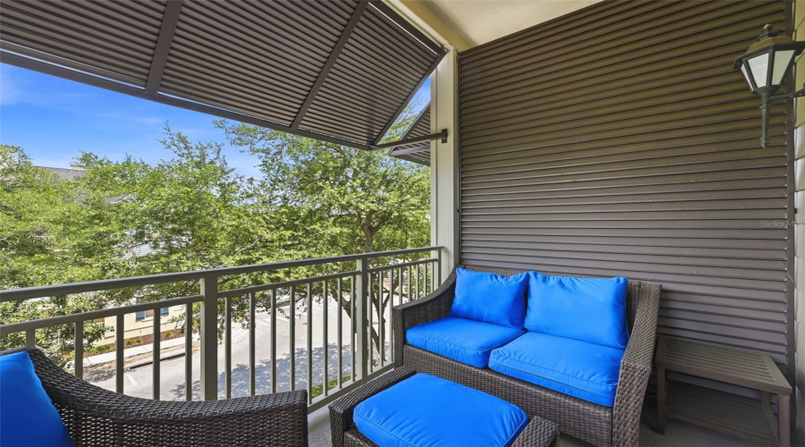 Balcony off Living Room with ceiling fan and coach light