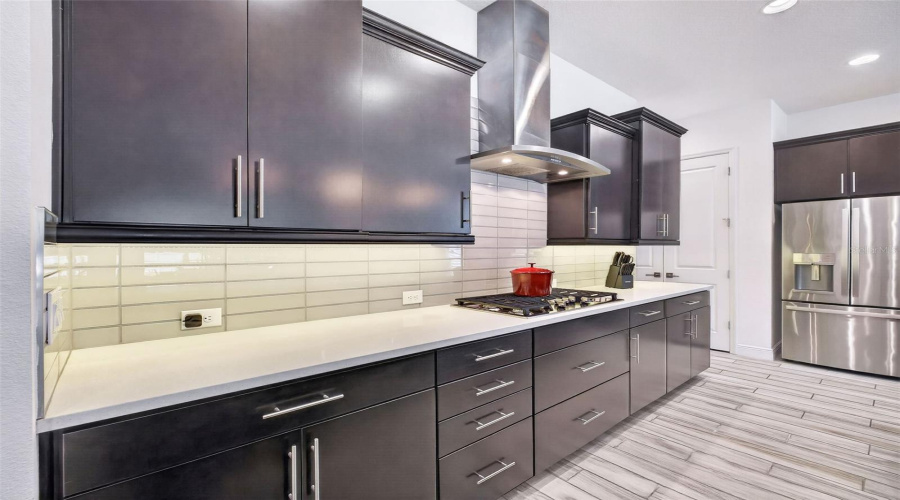 Under-counter lighting over cool tile black splash