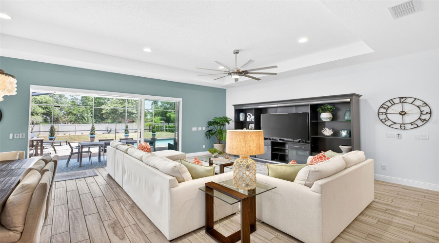 Living room with remote controlled blinds over sliding doors