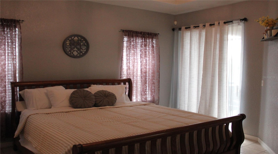 Master suite with full bath and access to patio and pool