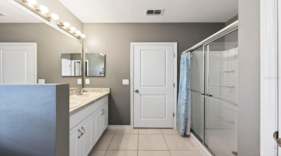 The Primary Bedroom features a GENEROUS WALK-IN CLOSET and an EN SUITE BATH with dual sinks and a step-in shower, creating a peaceful retreat at the end of the day.