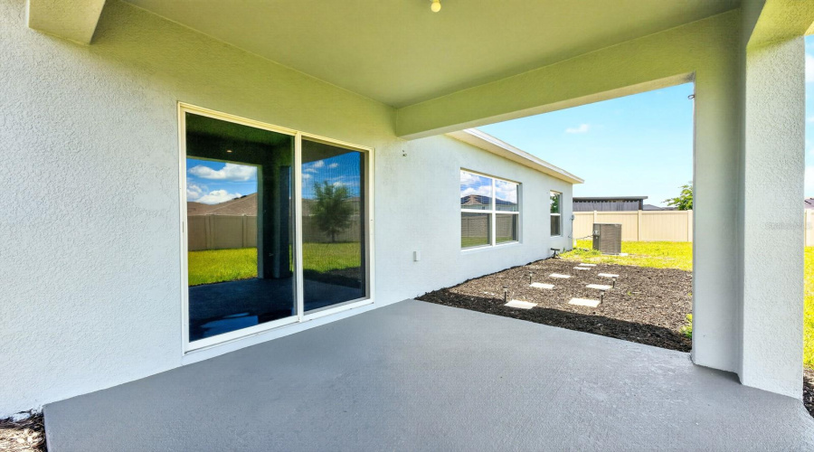 Sliding glass doors open directly to the covered rear patio and SPACIOUS BACKYARD, offering plenty of room to relax, entertain, garden, or create your own outdoor oasis.