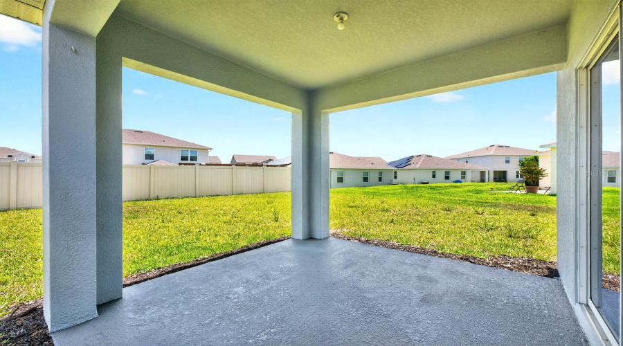 Sliding glass doors open directly to the covered rear patio and SPACIOUS BACKYARD, offering plenty of room to relax, entertain, garden, or create your own outdoor oasis.