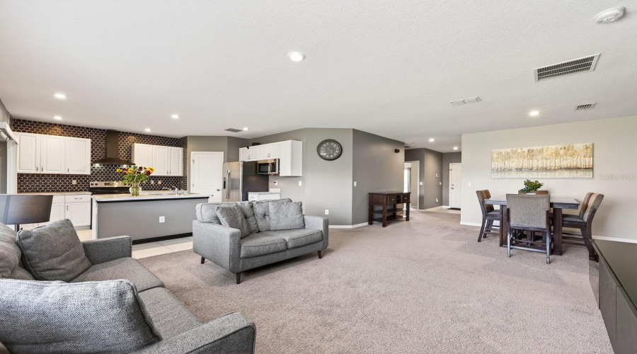 Conveniently adjacent to the Kitchen and Dining area, the Living Room invites connection and comfort.