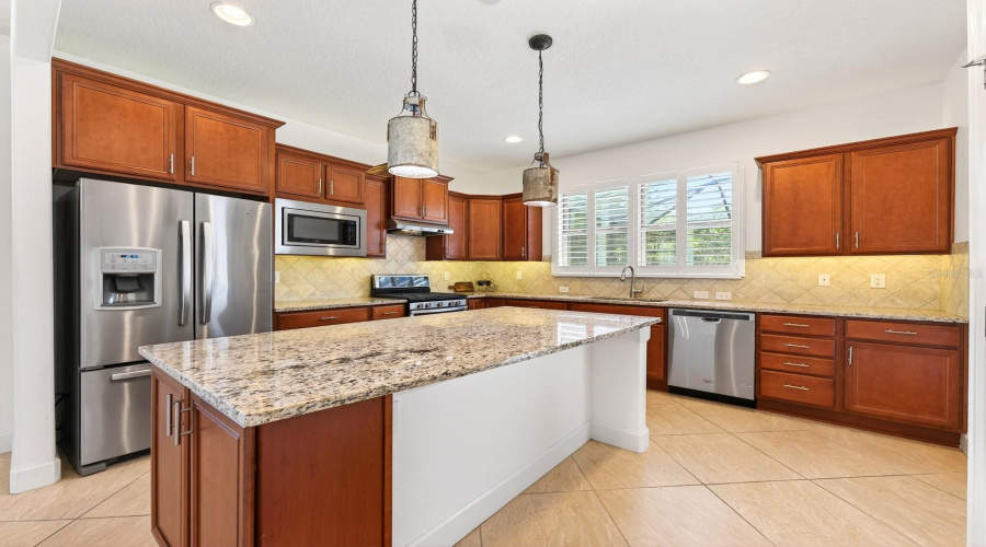 The Kitchen island is designed to accommodate counter-height stools, adding both function and casual seating.
