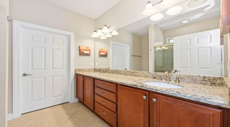 The PRIMARY EN SUITE BATH offers dual sinks, a step-in shower, and a walk-in closet, creating a relaxing and functional retreat.
