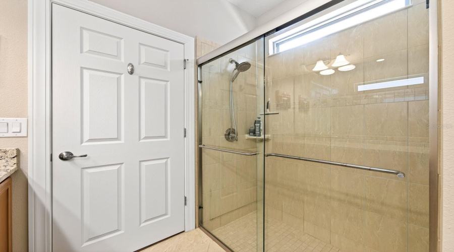 The PRIMARY EN SUITE BATH offers dual sinks, a step-in shower, and a walk-in closet, creating a relaxing and functional retreat.