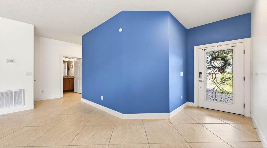 From the moment you arrive, the home impresses with its BRICK PAVER DRIVEWAY AND WALKWAY leading to a stunning ETCHED GLASS FRONT DOOR, creating beautiful curb appeal and a warm welcome.