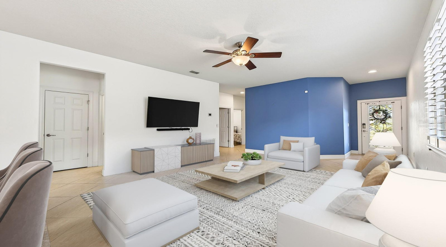 Inside, the home features PORCELAIN TILE FLOORING throughout the main living areas, while windows with PLANTATION SHUTTERS fill the space with NATURAL LIGHT and timeless elegance. Virtually Staged