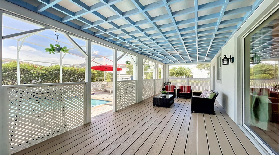Covered lanai with upgraded wood flooring / wood ceiling accents.