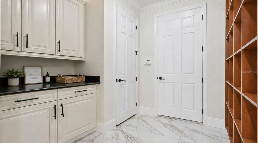 A functional drop zone featuring built-in storage, custom cabinetry, and plenty of space to keep everyday essentials organized and out of sight