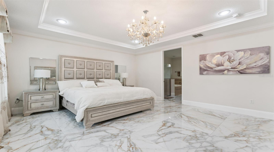 Generously sized and filled with natural light, this serene primary suite offers the perfect blend of comfort, privacy, and relaxation