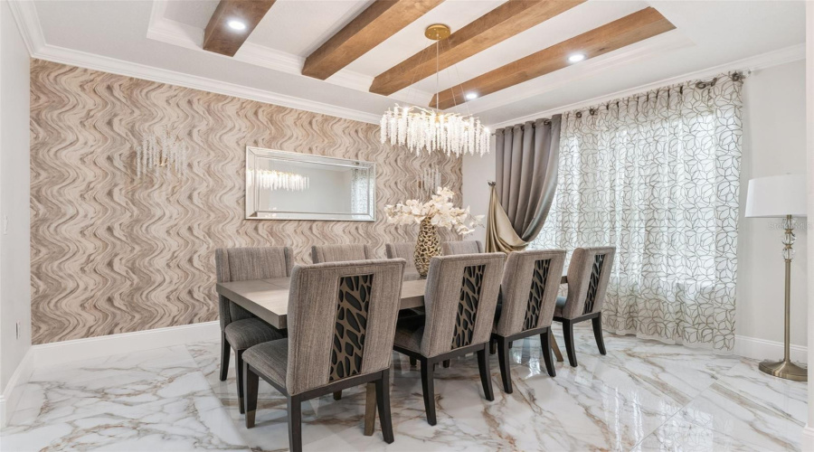 Elegant formal dining room highlighted by beautiful wood beam accents that add warmth and architectural character