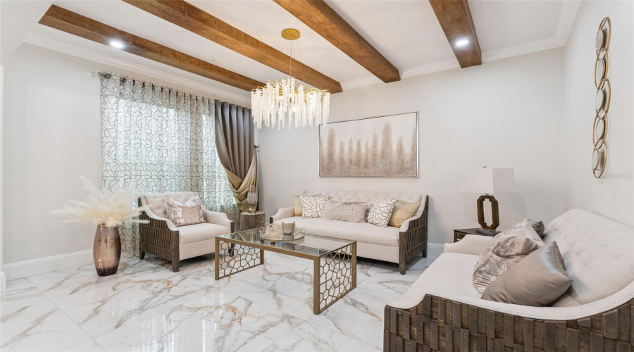 The dining room flows seamlessly into the formal living area, creating an inviting space for entertaining and special gatherings