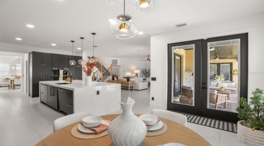 This dining nook sits just off the kitchen with direct access to the covered outdoor living area, creating a natural indoor-outdoor flow.
