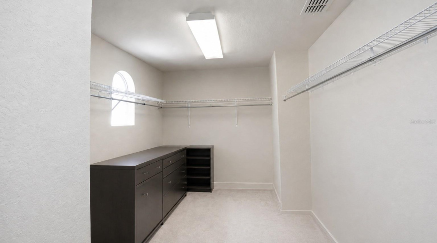 Primary closet with items removed (staged)