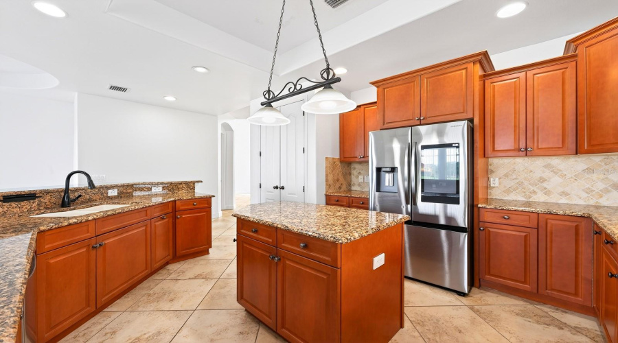 Stainless steel appliances—including a SAMSUNG SMART REFRIGERATOR (2023)—make the Kitchen as functional as it is beautiful.