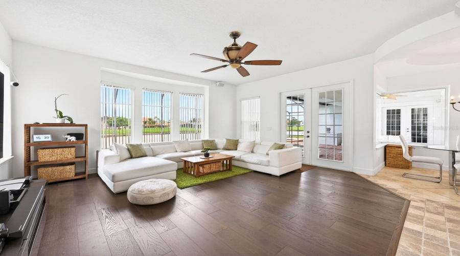 The Kitchen flows seamlessly into the EXPANSIVE FAMILY ROOM, where numerous windows and FRENCH DOORS flood the space with natural light.