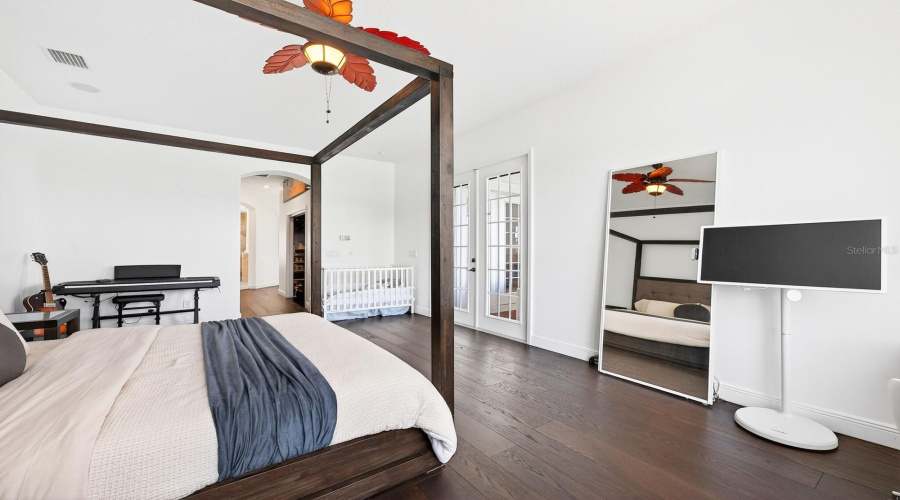 The luxurious Primary Suite serves as a private retreat with dual closets, a SPA-INSPIRED EN SUITE BATH, and french doors leading to the patio/pool area.