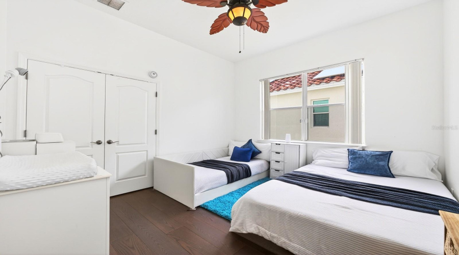 Two bedrooms are conveniently located on the main floor, each featuring NEW ENGINEERED HARDWOOD FLOORING (2024) and walk-in closets. Bedroom 2