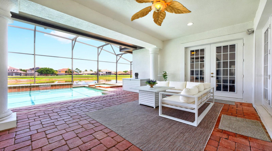 Experience ultimate relaxation in your backyard sanctuary, complete with a SCREENED-IN HEATED POOL, soothing spa, and a NEW POOL HEATER (2023), all while taking in SCENIC VIEWS of the Providence Golf Club's picturesque water feature.