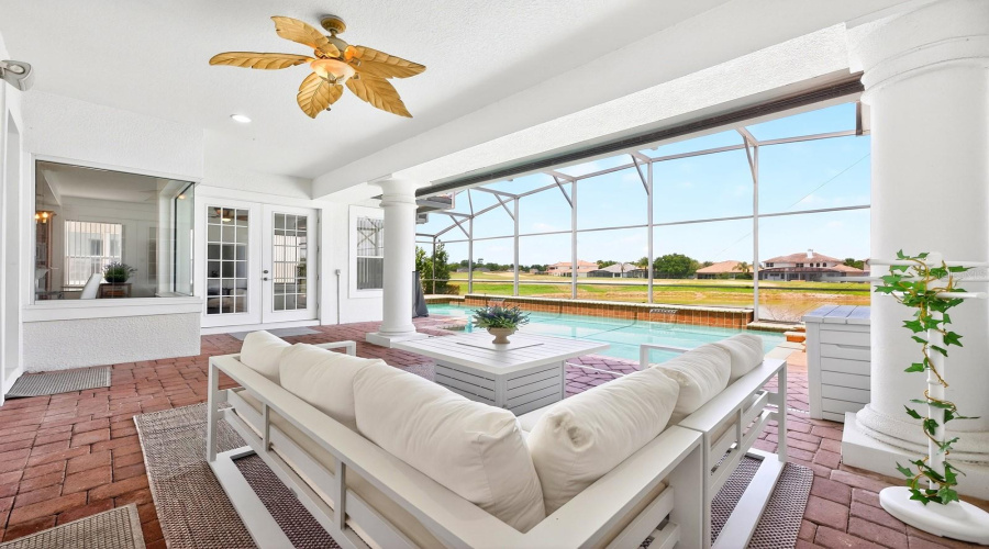 Experience ultimate relaxation in your backyard sanctuary, complete with a SCREENED-IN HEATED POOL, soothing spa, and a NEW POOL HEATER (2023), all while taking in SCENIC VIEWS of the Providence Golf Club's picturesque water feature.