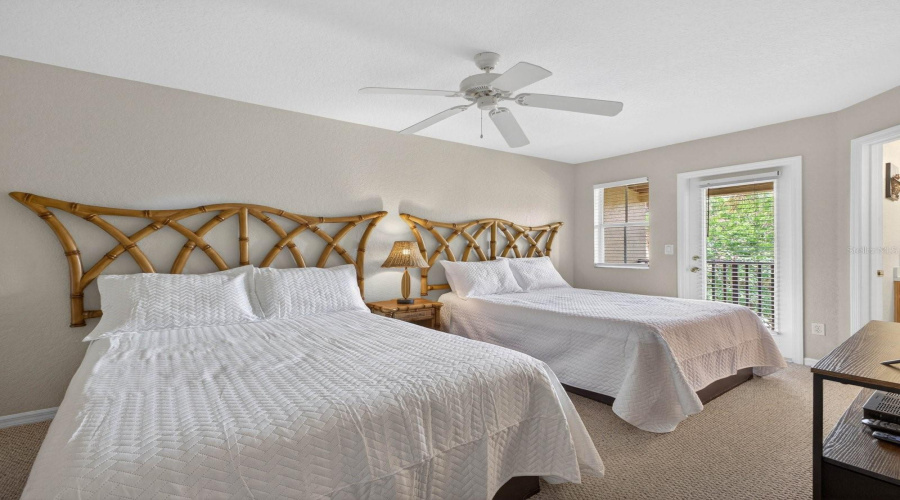 Another view of upstairs bedroom with access to exterior deck.