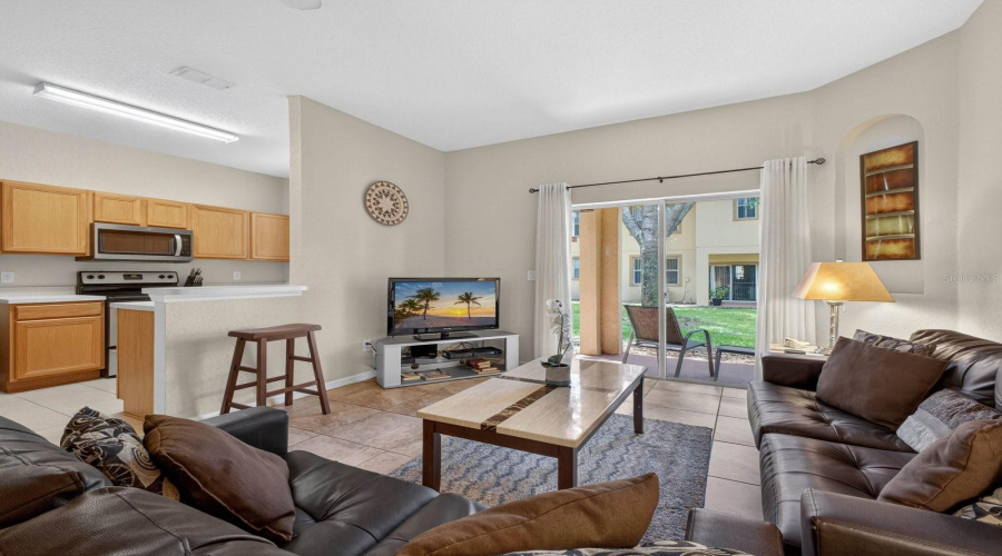 Living room with sliding glass door to covered porch.