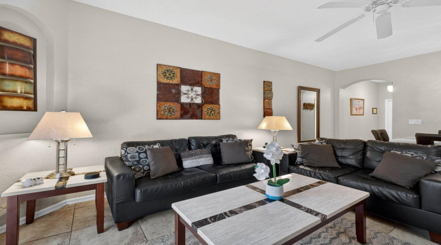 Another angle of the living room, showcasing the ceiling fan.