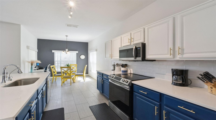 Modern kitchen featuring quartz countertops and custom cabinetry