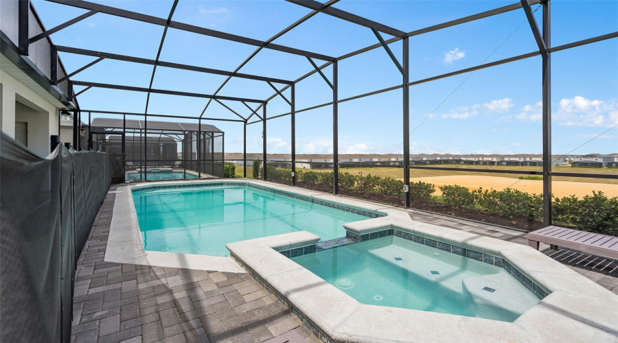 screened in pool with spa