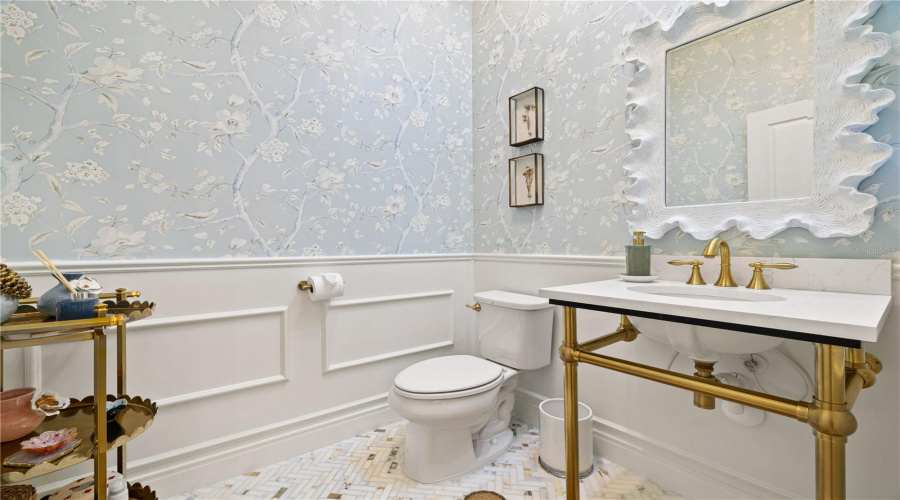 1/2 bathroom with boiserie and wall paper.
