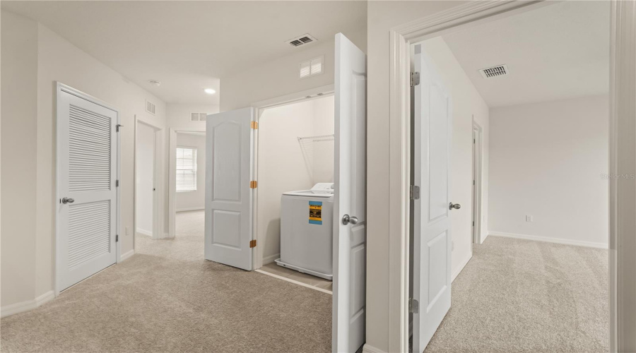 Loft landing with view to primary bedroom.