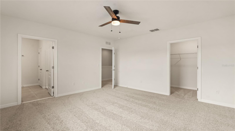 Primary Bedroom with view to walk-in closet